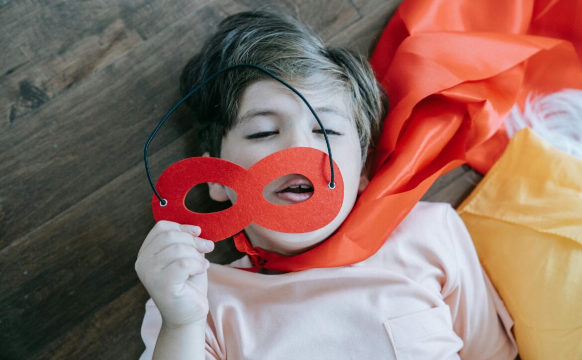 kid taking nap dressed as superhero
